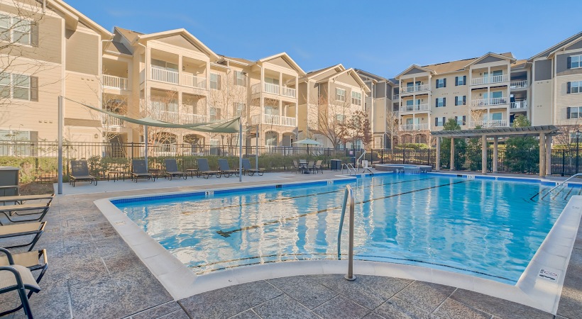 Resort-style swimming pool with lounge seating